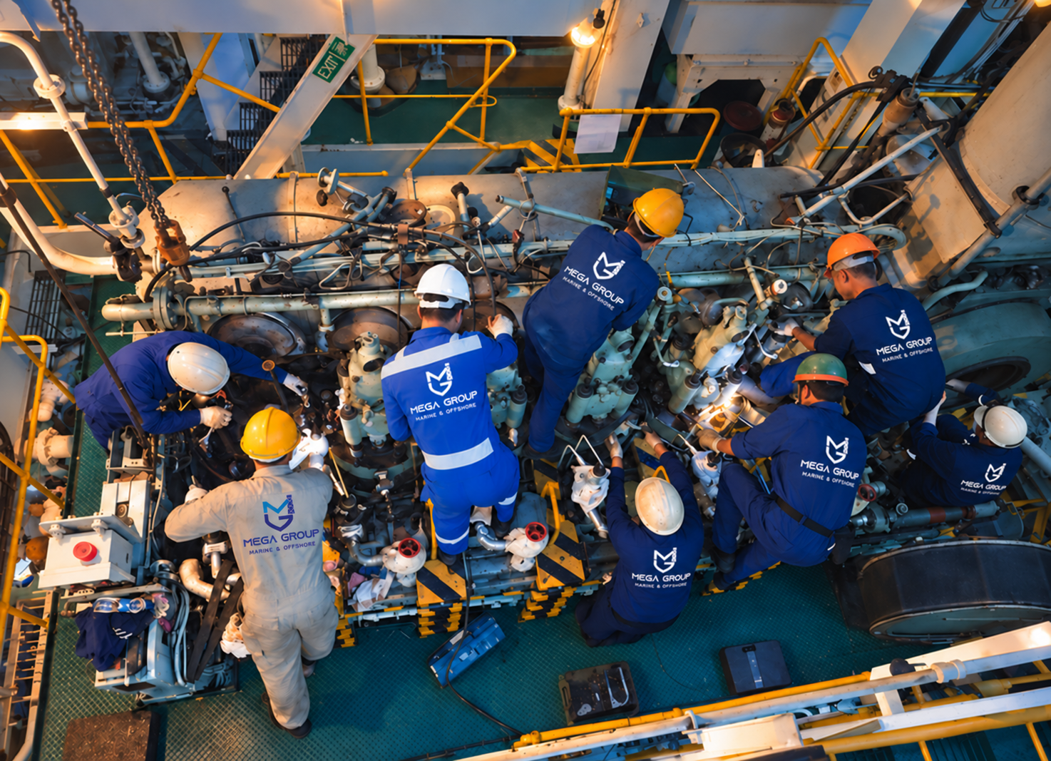 Mega Group engineers working together in a ship’s engine room